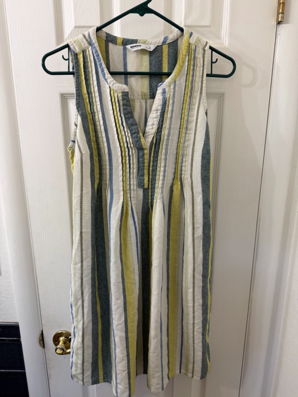 Sleeveless linen-blend dress featuring a colorful multi-green stripe pattern.